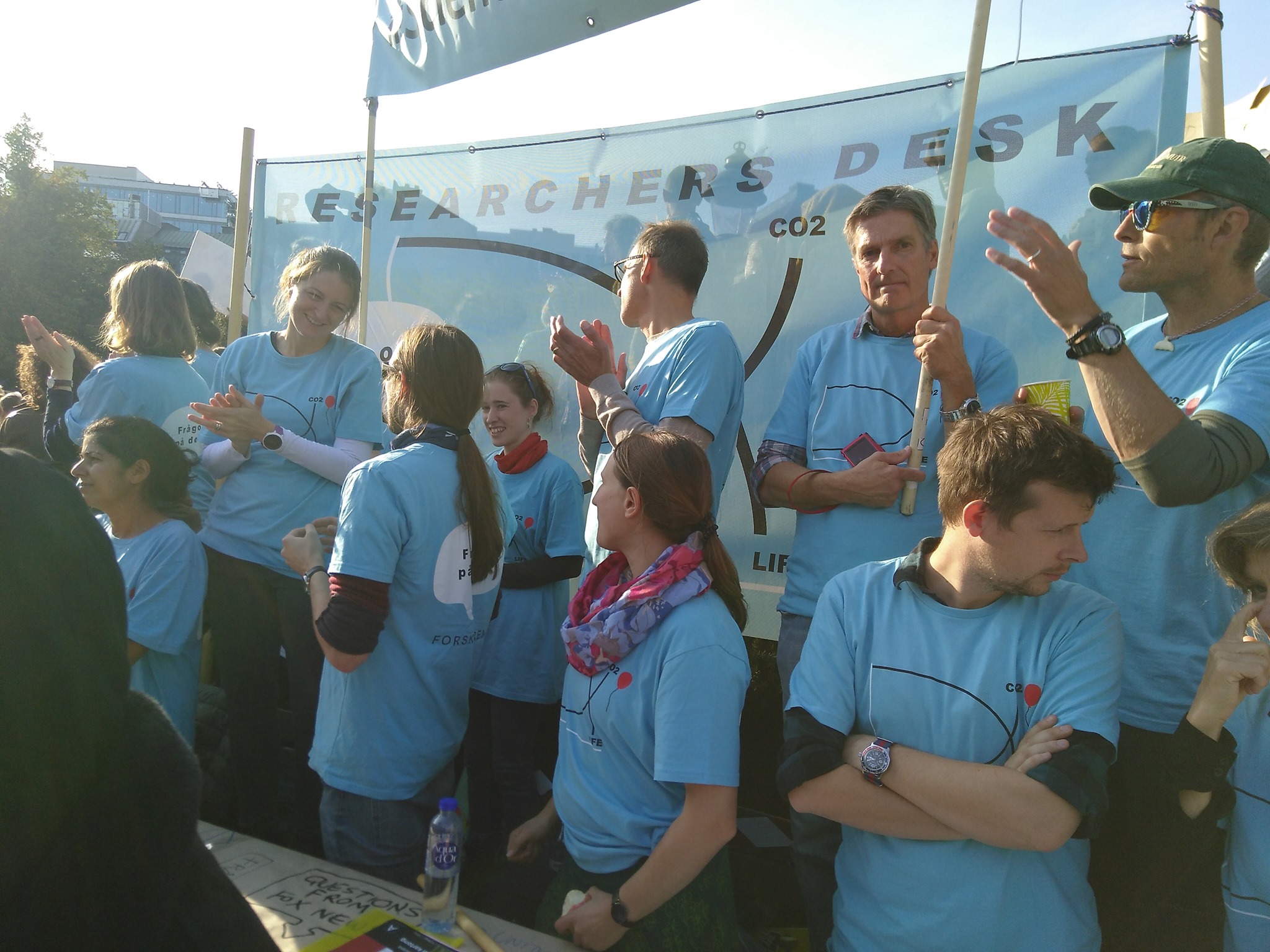 Approximately ten members of the Researchers' Desk gathered for a photo during a climate demonstration in Stockholm. The majority of them were donned in blue T-shirts.